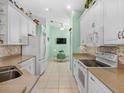 White kitchen with granite countertops and stainless steel appliances at 6655 41St Street E Cir, Sarasota, FL 34243