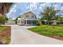 House exterior showcasing a driveway, detached garage, and landscaped yard at 1810 28Th W St, Bradenton, FL 34205