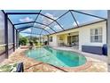 Inviting screened-in pool with a spa, complemented by ample patio space and a covered outdoor seating area at 1934 Mesic Hammock Way, Venice, FL 34292