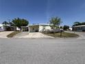 Exterior of a single-wide manufactured home with carport at 4906 Sea Island Ave, Sarasota, FL 34234