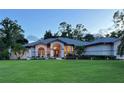 House exterior at dusk, well-lit entrance at 7430 Weeping Willow Dr, Sarasota, FL 34241