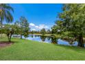 Serene backyard oasis with a lake view and lush landscaping at 7167 Whitemarsh Cir, Lakewood Ranch, FL 34202