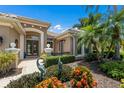 Beautifully landscaped front entrance with brick-paved walkway and decorative sculptures at 7167 Whitemarsh Cir, Lakewood Ranch, FL 34202