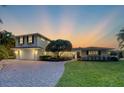 Modern two-story home with landscaped yard at dusk at 1701 Sandalwood Dr, Sarasota, FL 34231