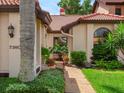 Landscaped walkway leads to a charming home with Mediterranean style at 7360 Oak Moss Dr # 4, Sarasota, FL 34241