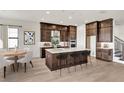 An expansive kitchen boasts dark wood cabinetry, a central island, and modern stainless steel appliances at 2625 Waterfront Cir, Sarasota, FL 34240