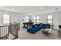 Bright living area featuring modern décor, a pool table, and a comfortable blue sectional sofa at 2625 Waterfront Cir, Sarasota, FL 34240