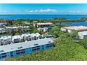 Beautiful aerial view of a condo community, with a pool, and lush green vegetation at 3607 E Bay Dr # 202, Holmes Beach, FL 34217