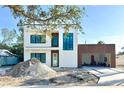Modern two-story home with a wood-accented carport and a minimalist design, still under construction at 2226 Grove St, Sarasota, FL 34239