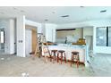 Spacious kitchen featuring an island with barstool seating and modern cabinetry, still under construction at 2226 Grove St, Sarasota, FL 34239