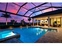 Relaxing pool and spa with covered patio at sunset at 8480 Lindrick Ln, Bradenton, FL 34202