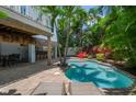 Inviting pool with patio, outdoor bar, and lush landscaping at 4805 2Nd Ave, Holmes Beach, FL 34217