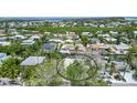 Wide aerial view showcasing home's waterfront location and neighborhood at 562 Juan Anasco Dr, Longboat Key, FL 34228