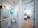 Small modern bathroom with white vanity, hexagon tile floor, and stylish mirror at 2446 Floyd St, Sarasota, FL 34239