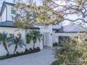 Modern two-story home nestled on a lot with lush landscaping and mature trees at 2420 Floyd St, Sarasota, FL 34239
