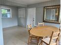 Dining area with wood table and chairs near a door at 2825 Sequoia Ln, Sarasota, FL 34237