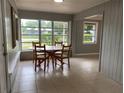 Bright dining area with wood table and chairs, and view to the outdoors at 2825 Sequoia Ln, Sarasota, FL 34237