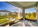 Relaxing screened porch overlooking backyard patio and grassy area at 5415 Limelight Dr, Apollo Beach, FL 33572