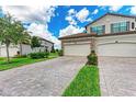 Three-car garage townhome with paver driveway and landscaping at 5922 Wake Forest Run # 101, Bradenton, FL 34211