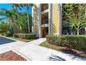 Condo building exterior with walkway and landscaping at 7607 Grand Estuary Trl # 205, Bradenton, FL 34212