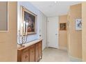 Bright condo entryway with wood cabinet and artwork at 1750 Benjamin Franklin Dr # 2G, Sarasota, FL 34236