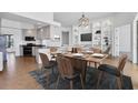 Open concept kitchen and dining area with modern appliances and built-in shelving at 5901 Mariposa Ln, Sarasota, FL 34238