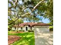 Single-story home with a two-car garage and mature landscaping at 623 147Th E St, Bradenton, FL 34212
