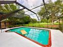 Inviting screened pool with brick coping and patio area at 623 147Th E St, Bradenton, FL 34212