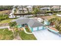 This waterfront property includes a three-car garage and boat storage at 613 Elba Dr, Nokomis, FL 34275