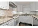 Renovated kitchen, featuring granite countertops and stainless steel appliances at 329 Bay Vista Ave, Osprey, FL 34229