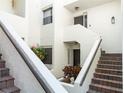 Inviting condo entrance featuring brick stairs, blooming flowers, and a 'Welcome' sign for a homey touch at 5174 Marsh Field Ln # 86, Sarasota, FL 34235
