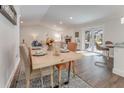 Bright dining area features stylish table setting, hardwood floors, and sliding doors to the outdoor patio at 1741 Jewel Dr, Sarasota, FL 34240