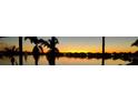 Stunning sunset view over a serene lake, showcasing the property's waterfront location at 177 Vinadio Blvd, Nokomis, FL 34275
