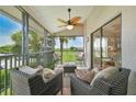 Relaxing screened porch with wicker furniture and golf course view at 26336 Nadir Rd # 12, Punta Gorda, FL 33983