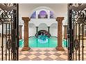 Stunning indoor pool with arched ceilings and elegant columns at 3482 Flamingo Ave, Sarasota, FL 34242