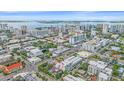 A scenic aerial view captures modern townhomes near the waterfront with city buildings in the distance at 1558 4Th St # 216, Sarasota, FL 34236