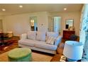 Cozy living room with a comfortable sofa, ottoman and a decorative rug, creating an inviting space at 221 Evergreen St, Punta Gorda, FL 33982