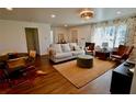 Bright living room featuring a neutral sofa, vibrant rug, and stylish furniture arrangement at 221 Evergreen St, Punta Gorda, FL 33982
