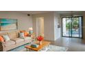 Bright living room with comfy sofa and access to patio at 2232 Bahia Vista St # A2, Sarasota, FL 34239