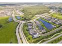 Wide aerial view of a residential area with houses, roads, and a lake at 8370 Velda Trl, Sarasota, FL 34241