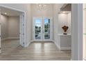 Elegant entryway with double doors and light neutral color palette at 2319 Webber St, Sarasota, FL 34239