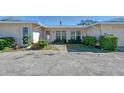 Neat and clean exterior of a light colored home with walkway at 2488 Breakwater Cir, Sarasota, FL 34231