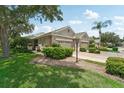 Well-maintained home exterior with stone accents and lush landscaping at 4951 Lakescene Pl, Sarasota, FL 34243