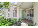 Charming front porch with seating and brick flooring at 4951 Lakescene Pl, Sarasota, FL 34243