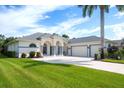 Single-story house with a three-car garage and well-manicured lawn at 15923 29Th E St, Parrish, FL 34219