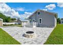 Gray house with firepit and paved patio at 2416 7Th W Ave, Bradenton, FL 34205