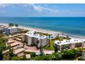 Aerial view of beachfront condo building with parking and ocean views at 4825 Gulf Of Mexico Dr # 105, Longboat Key, FL 34228