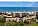 Aerial view of beachfront condo building with parking and ocean views at 4825 Gulf Of Mexico Dr # 105, Longboat Key, FL 34228