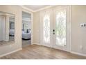 Bright entryway with double doors and view into bedroom at 4931 Oxford Dr, Sarasota, FL 34242