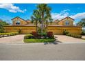 Tan three-unit building with paved driveways at 8106 Miramar Way, Lakewood Ranch, FL 34202